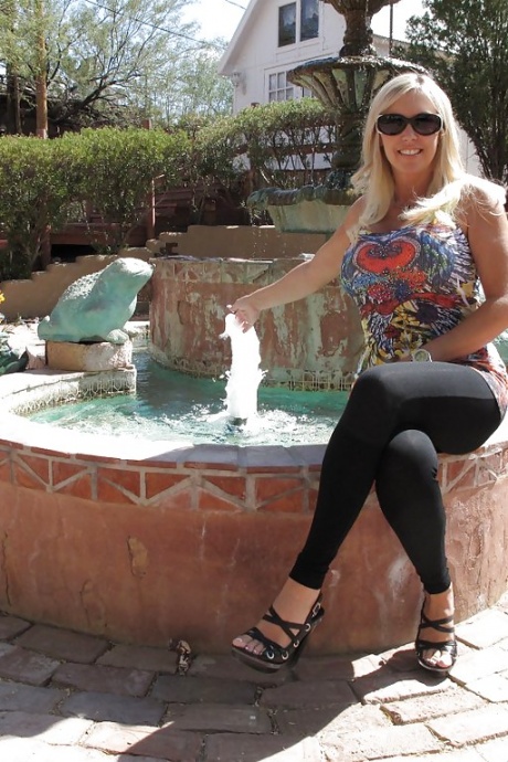 Потрясающая мамаша с большими сиськами и стройными ножками раздевается на открытом воздухе 2