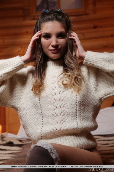 Великолепная молоденькая Эмилия Хопс снимает большой свитер, чтобы позировать обнаженной в чулочно-носочных изделиях OTK